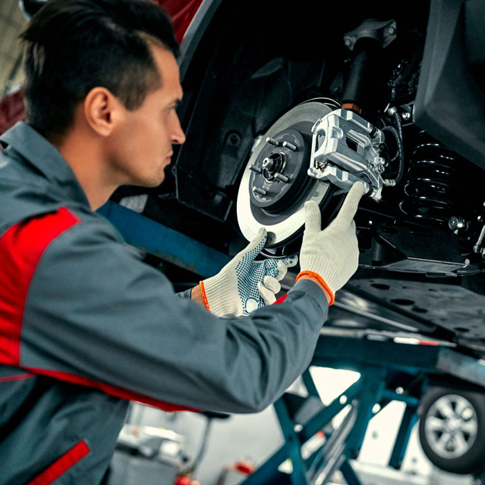 mechanic working on car brake