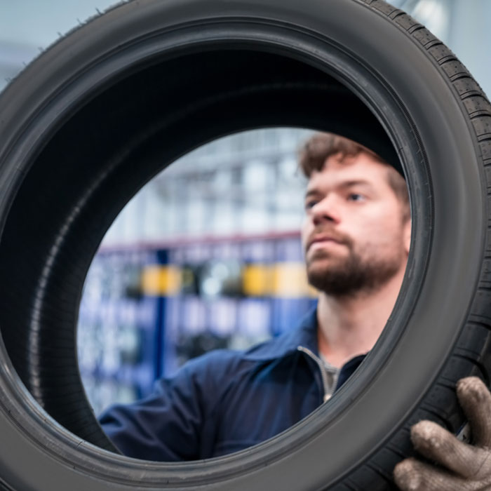 mechanic inspecting tire