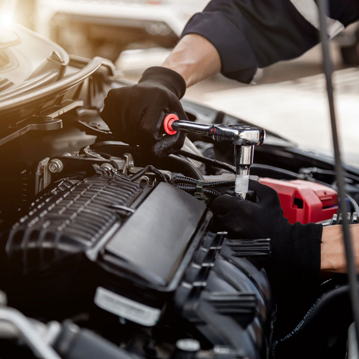 mechanic working on car engine