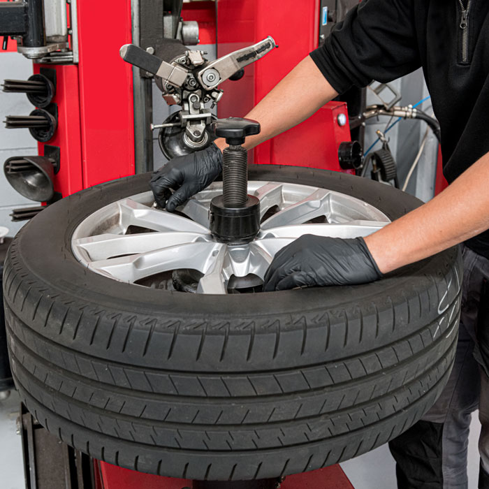mechanic working on car tire