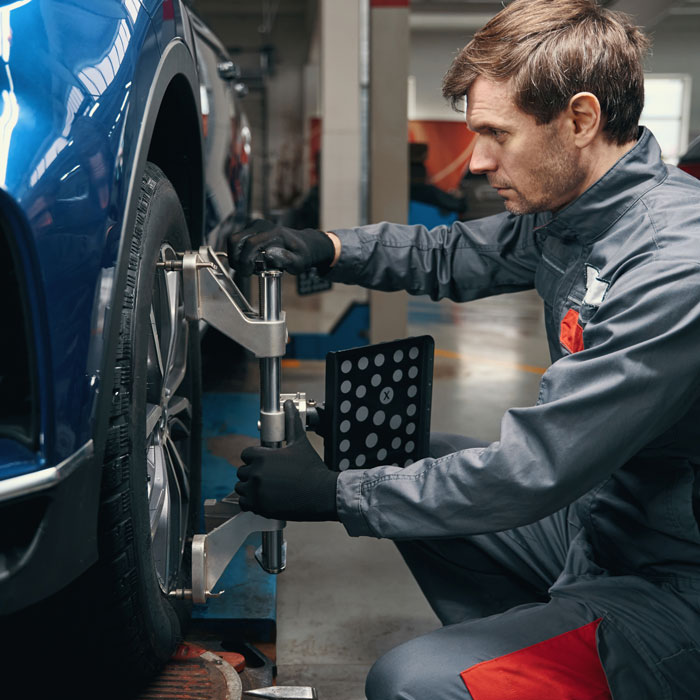 mechanic doing wheel alignment