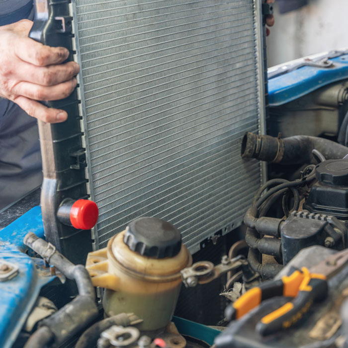 mechanic removing car radiator