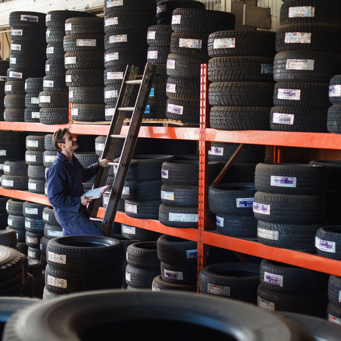 mechanic looking through tire inventory